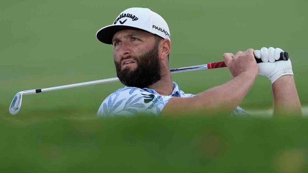 Jon Rahm from Spain plays a bunker shot on the first hole during the 2023 DP World Tour Championship golf tournament in Dubai, United Arab Emirates.